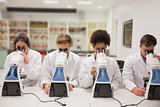 Medical students working with microscope