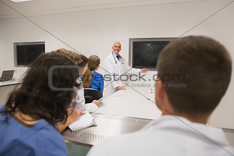 Medical professor teaching young students