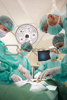 Medical students practicing surgery on model