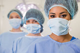 Medical students in operating theater looking at camera
