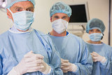 Medical student and lecturer looking at camera in scrubs
