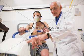 Doctor with man doing fitness test