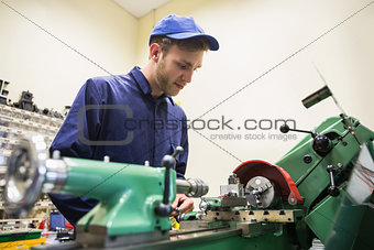 Engineering student using heavy machinery