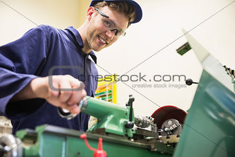 Engineering student using heavy machinery