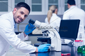 Science student working with microscope in the lab