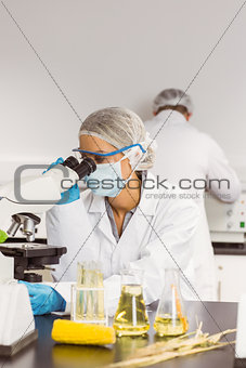 Food scientist using the microscope