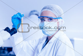 Food scientist holding test tube of corn