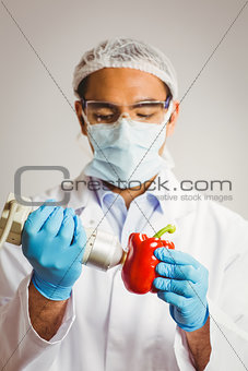 Food scientist using device on pepper