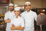 Team of bakers smiling at camera