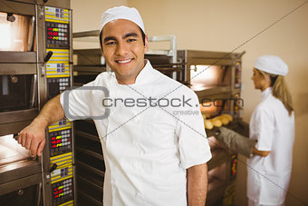 Handsome baker smiling at camera