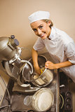 Baker using large mixer to mix dough