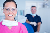 Smiling assistant with protective glasses