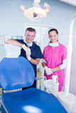 Smiling dentist and assistant with protective glasses