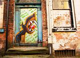  derelict doorway covered in graffiti