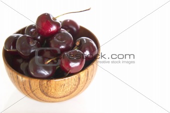 Bowl of cherries on white background