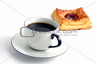 Coffee and a bun on white background