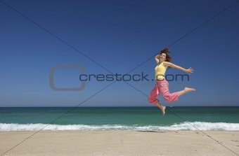 beautiful woman jumping in the beach