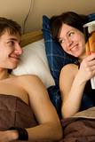 young happy couple in bedroom