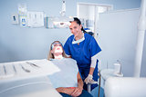 Dentist sitting over patient in the chair