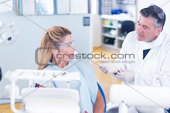 Dentist talking with his patient
