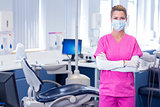 Dentist in surgical mask standing with arms crossed