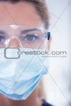 Close up of a dentist in mask looking at camera