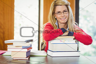 Smiling mature student with stack of books