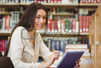 Smiling pretty student using tablet computer