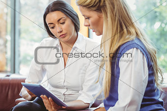 Business team talking and using tablet