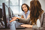 Businesswomen looking at computer screen together