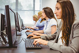 Four focused women working in computer room