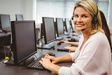 Smiling call centre agent talking on the headset