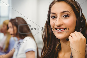 Smiling call centre agent talking on the headset