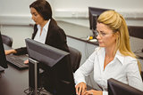Focused businesswomen working in computer room