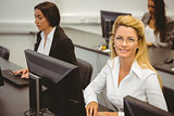 Smiling businesswoman working in computer room