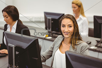 Smiling businesswoman working in computer room