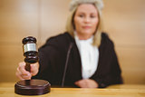 Serious judge with a gavel wearing robes and wig