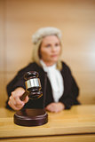 Serious judge with a gavel wearing robes and wig
