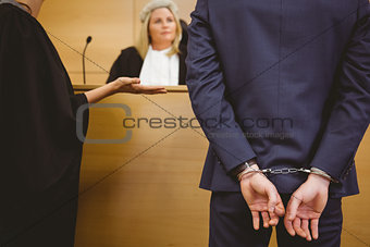 Judge talking with the criminal in handcuffs
