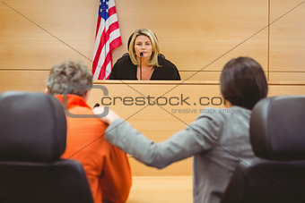 Judge and lawyer discussing the sentence for prisoner