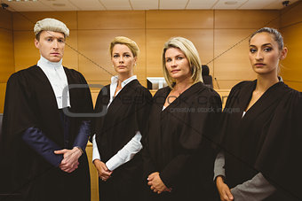 First judge standing while wearing a wig