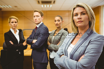 Serious lawyer standing with arms crossed