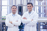 Scientist team smiling at camera with arms crossed