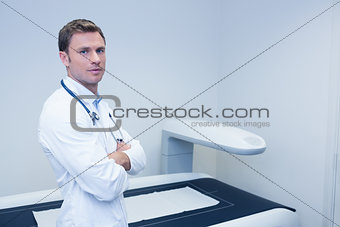 Confident male doctor with arms crossed