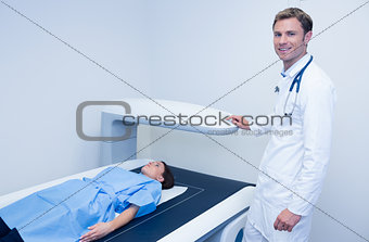 Smiling doctor doing a radiography on a patient
