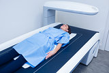 Sick woman lying on a x-ray machine