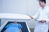 Smiling doctor proceeding a radiography on a patient