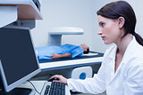 Doctor looking her computer while proceeding a radiography