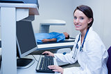 Smiling doctor with stethoscope in radiography room