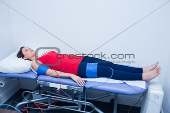 Doctor checking blood pressure of woman